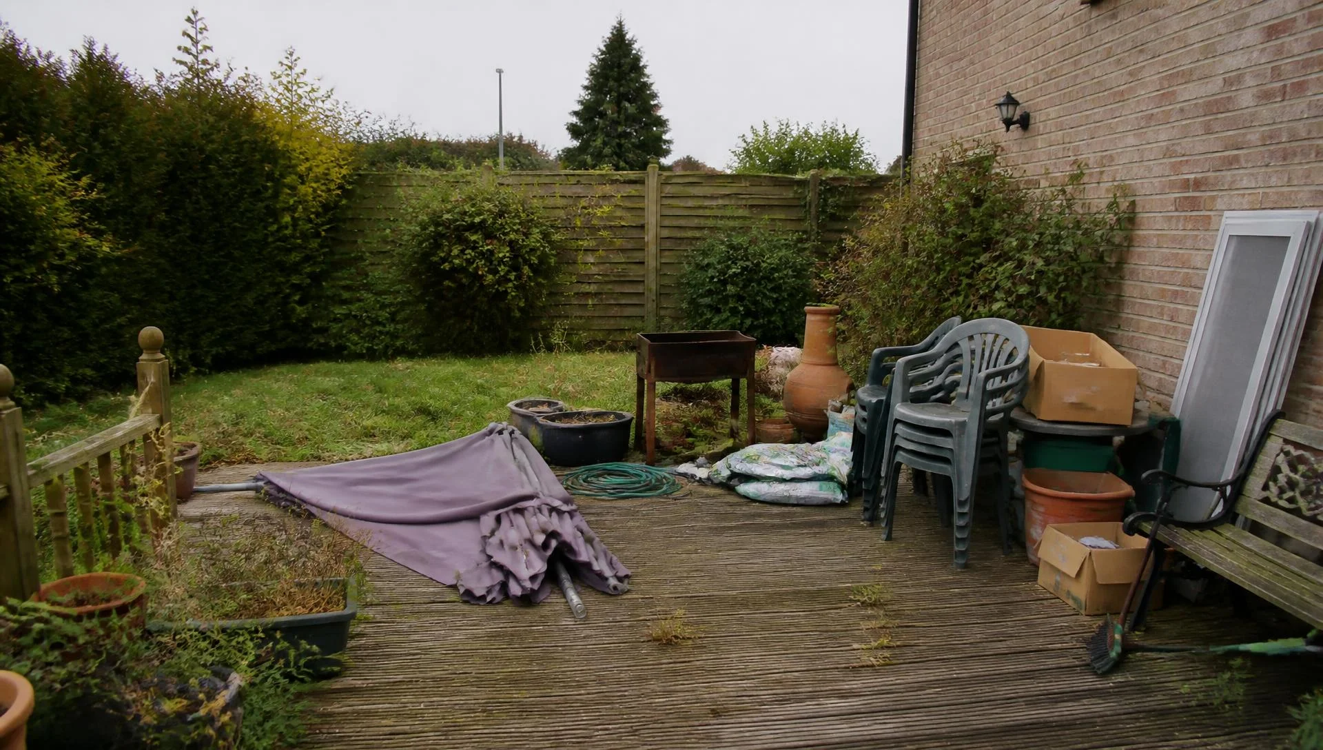 Cluttered backyard terrace full of junk before AI Clear Outdoor Space