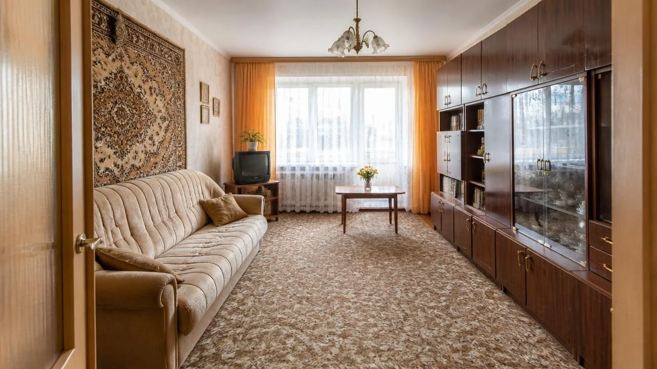 Original retro living room interior with a large window, curtains, a chandelier, and a vintage television.