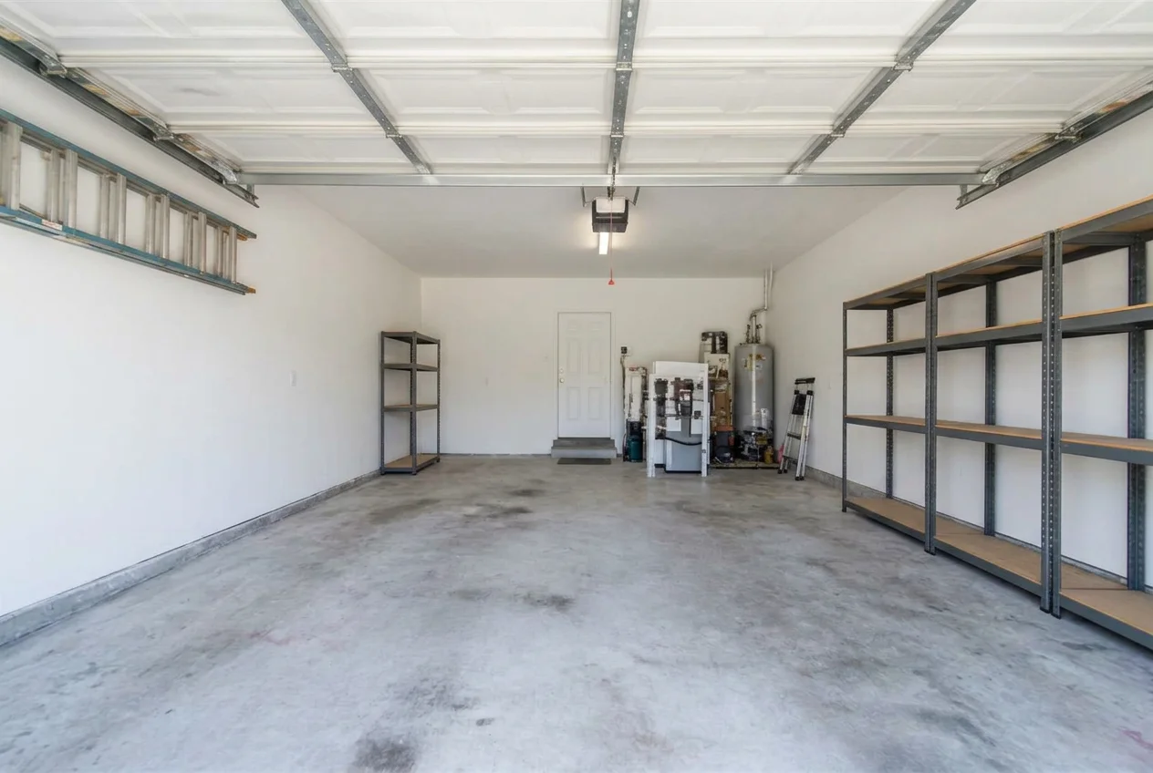 Empty clean garage after AI Virtual Decluttering removed boxes, tools and bikes